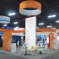 NRC Health's new 20x20 island features a 14' tall backlit LightWall, FabLite displays for use in smaller configurations. A combination rental/purchase from Vision Exhibits.